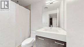 Toronto (South Riverdale) condo for rent - A bathroom with a toilet, sink and mirror.