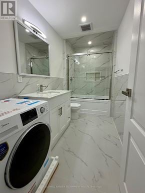 Halton Hills (Ac Acton) apartment for rent - A white washing machine is in a bathroom with marble floors and white walls.