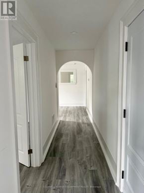 Halton Hills (Ac Acton) apartment for rent - A long hallway with white doors and grey wood flooring.