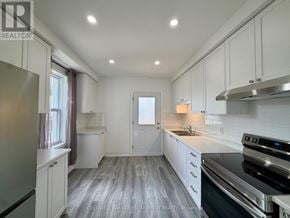 Halton Hills (Ac Acton) apartment for rent - A modern kitchen with white cabinets and a stainless steel stove.