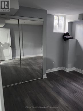 Brampton (Madoc) apartment for rent - A room with a sliding glass door and wooden flooring.