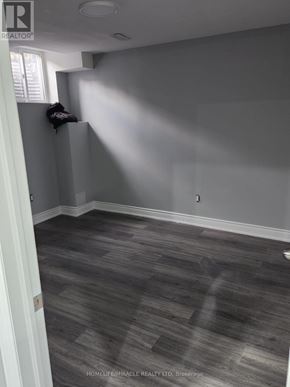 Brampton (Madoc) apartment for rent - A room with grey flooring and a white door.