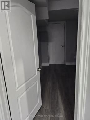 Brampton (Madoc) apartment for rent - A hallway with a white door on the left and a closed door on the right.
