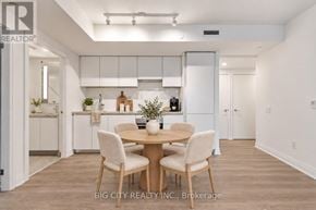 Toronto (Thorncliffe Park) condo for rent - A dining area with a table and chairs in a modern kitchen.