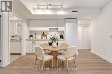 Toronto (Thorncliffe Park) condo for rent - A dining area with a table and chairs in a modern kitchen.