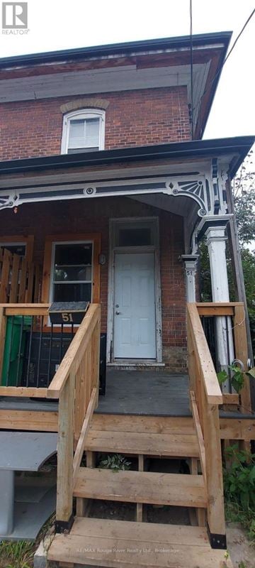 Peterborough (Town Ward 3) triplex for rent - A house with a white door and a porch.