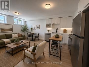 Russell apartment for rent - A modern kitchen and living room with a dining table and chairs.