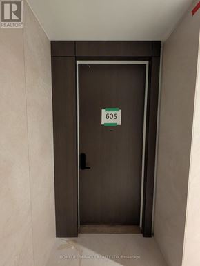 Toronto (Annex) condo for rent - A brown door with a sign that says 605 on it.