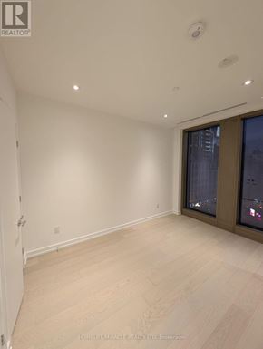 Toronto (Annex) condo for rent - A room with a sliding glass door and wooden flooring.