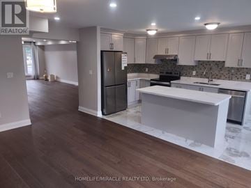 Toronto (Kennedy Park) apartment for rent - A kitchen with a black refrigerator and white countertops.
