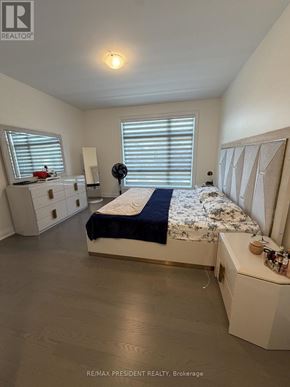 Vaughan (Vellore Village) apartment for rent - A bedroom with a bed, nightstand, and window with blinds.