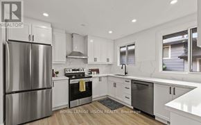 Niagara Falls (Church's Lane) apartment for rent - A modern kitchen with white cabinets and stainless steel appliances.