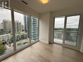 Toronto (Willowdale East) condo for rent - A room with a view of a cityscape through large windows.