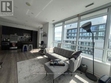 Toronto (Church-Yonge Corridor) condo for rent - A living room with a grey couch and a large window.