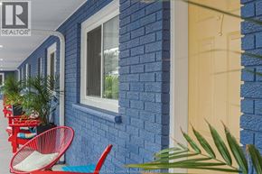 Erieau apartment for rent - A blue brick house with a white door and a window.
