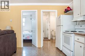 Erieau apartment for rent - A realtor photo of a kitchen and bedroom.