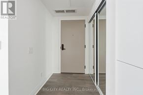 Toronto (Thorncliffe Park) condo for rent - A hallway with a door and a wall with a logo on it.