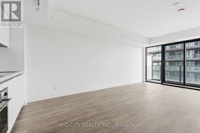 Toronto (Thorncliffe Park) condo for rent - A spacious room with wooden flooring and a large window.