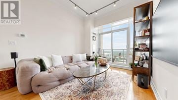 Toronto (Bayview Village) condo for rent - A living room with a large couch and a glass table.