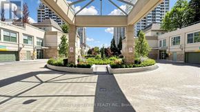 Toronto (Bayview Village) condo for rent - A real estate company's brokerage office with a landscaped courtyard in the foreground.