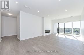 Guelph (Pineridge/Westminster Woods) condo for rent - A spacious room with a fireplace and large windows.