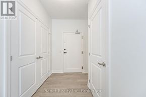 Guelph (Pineridge/Westminster Woods) condo for rent - A hallway with white doors and a wooden floor.