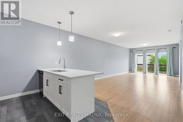 The Nation fourplex for rent - A kitchen with a sink and cabinets in a room with wooden floors.