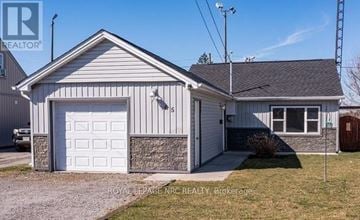 Port Colborne (Main Street) apartment for rent - A two-car garage with a white door is situated in front of a house.