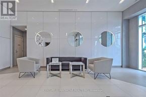 Toronto (Woburn) condo for rent - A modern waiting area with a grey sofa, two chairs and a table.
