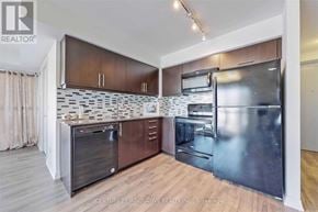 Toronto (Woburn) condo for rent - A modern kitchen with wooden cabinets and stainless steel appliances.