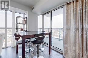 Toronto (Woburn) condo for rent - A dining room with a table and chairs and a view of the city.