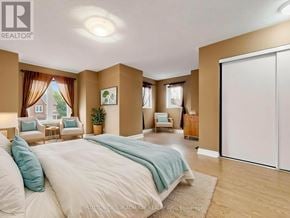 Vaughan (Maple) townhouse for rent - A bedroom with a large bed and a sliding door.
