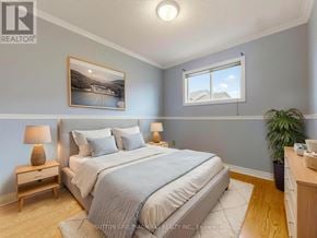 Vaughan (Maple) townhouse for rent - A bedroom with a large bed and a painting on the wall.