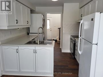 Barrie (Innis-Shore) apartment for rent - A kitchen with white cabinets and a white refrigerator.