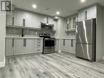 Brampton (Northwest Brampton) apartment for rent - A kitchen with a stainless steel refrigerator and wooden flooring.