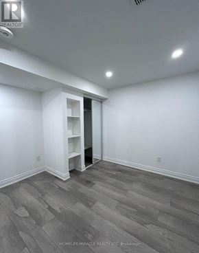 Brampton (Credit Valley) apartment for rent - A room with a grey floor and a white wall with a doorway leading to another room.