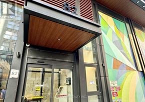 Toronto (Church-Yonge Corridor) condo for rent - The image shows the front of a building with a glass door and a sign that reads "82".