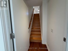 Toronto (Rockcliffe-Smythe) apartment for rent - A staircase with wooden steps and white walls.