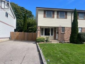 Oshawa (Eastdale) apartment for rent - A residential house with a driveway and a fence.