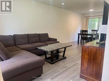 Oshawa (Eastdale) apartment for rent - A living room with a brown sofa and a coffee table.