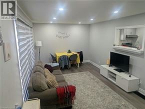 Brantford apartment for rent - A living room with a couch, a table, and a television.