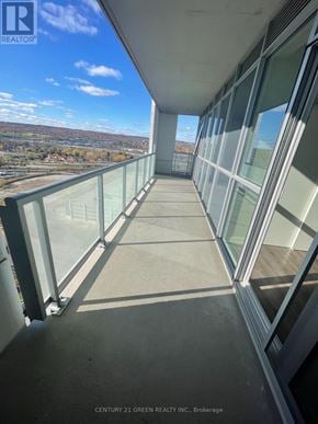 Burlington (Freeman) condo for rent - A balcony with glass railings overlooks a valley.