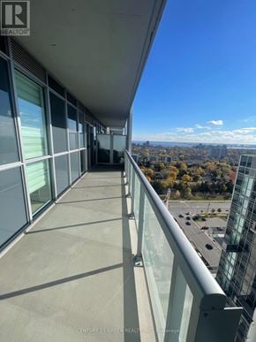Burlington (Freeman) condo for rent - A balcony with glass railings overlooks a cityscape.