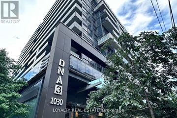 Toronto (Niagara) condo for rent - A tall building with the number 1030 and the words Loyalty Real Estate Brokerage on it.