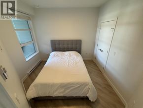 Coquitlam apartment for rent - A bedroom with a bed, a window, and a door.