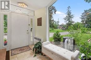 Ottawa house for rent - A realtor photo of a home with a white door and a bench.