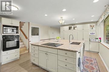 Ottawa house for rent - A kitchen with a marble countertop and a refrigerator with a built-in oven.