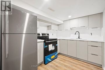Toronto (Wexford-Maryvale) apartment for rent - A modern kitchen with a stainless steel refrigerator and white cabinets.