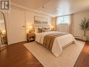 London East (East F) multi-family for rent - A bedroom with a large bed and a painting on the wall.