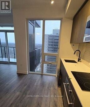 Toronto (Mount Pleasant West) condo for rent - A kitchen with a view of a cityscape through the window.